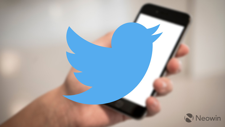 Twitter logo on top of a picture of an iPhone in someones hand