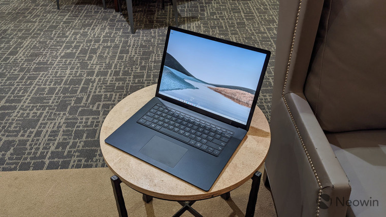 Surface Laptop 3 on a round table next to a couch