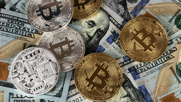 Stock image of Bitcoin and US Dollars