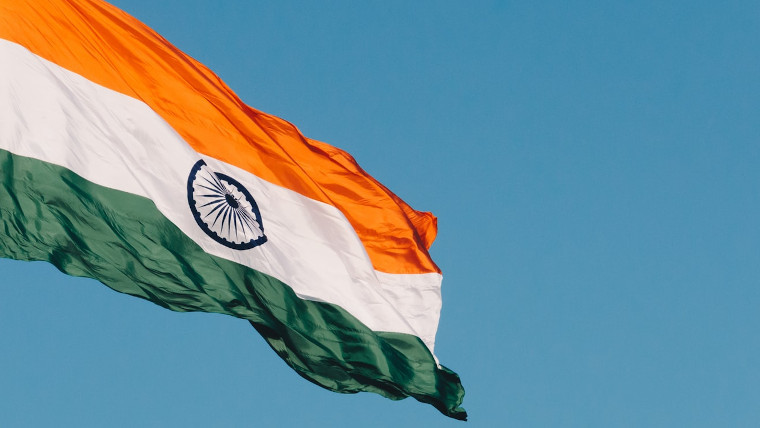 The Indian flag against a blue sky