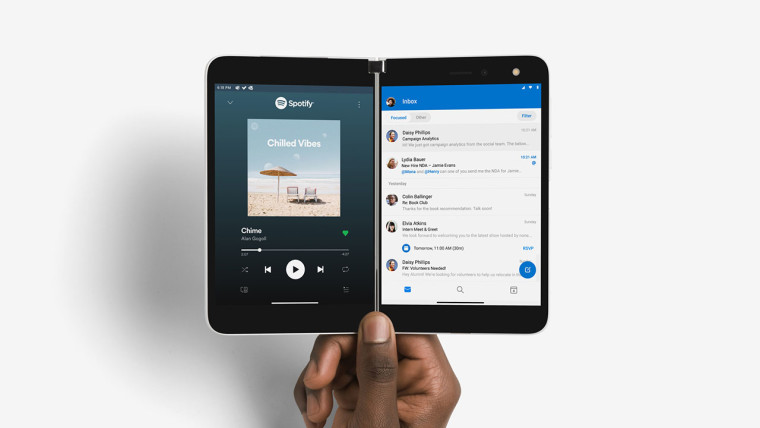 Fully open Surface Duo being held by its hinge in the middle