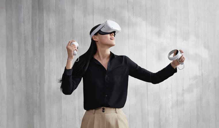 A woman using an Oculus Quest 2 headset