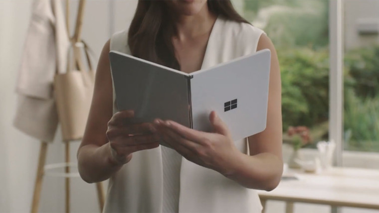 A woman holding a Surface Neo like a book