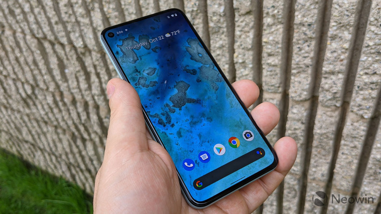 A Pixel 5 held face-up in a persons hand