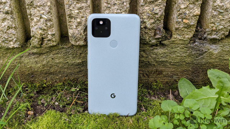 Google Pixel 5 standing vertically against a stone wall