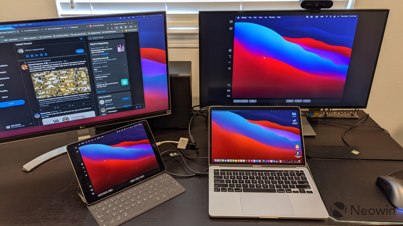 MacBook Pro and iPad Pro connected to two monitors