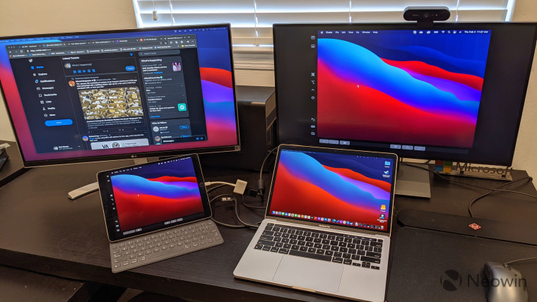 MacBook Pro and iPad Pro connected to two monitors