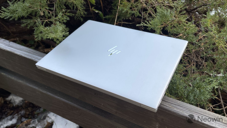 Silver HP Envy 14 closed on wooden gazebo