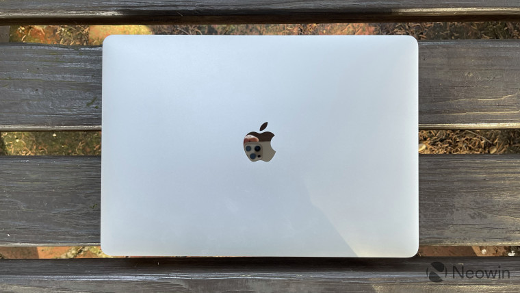 Top-down view of MacBook Pro on wooden bench