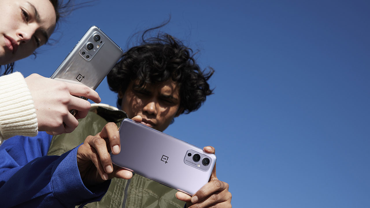 Users holding OnePlus 9 and OnePlus 9 Pro