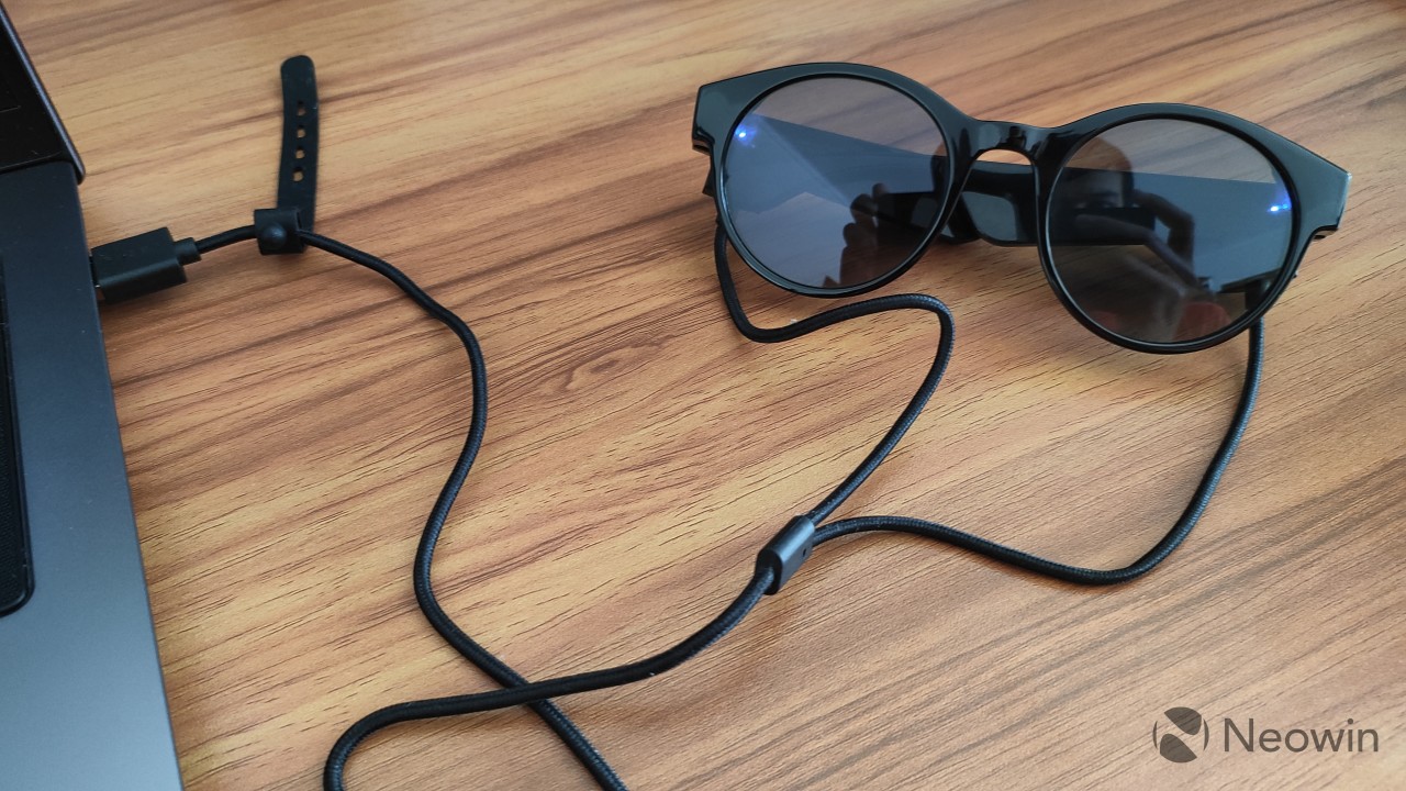 Razer Anzu Smart Glasses connected to the including pin charger