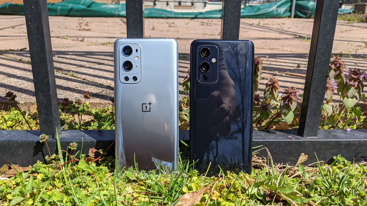 OnePlus 9 Pro and OnePlus 9 standing against fence