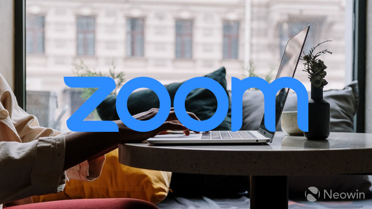 The Zoom logo with a laptop in the background