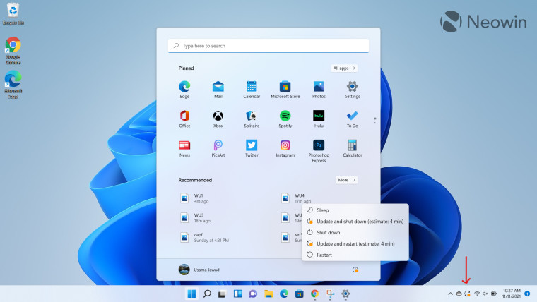 Windows 11 desktop open with Windows Update pending arrow on icon in Taskbar