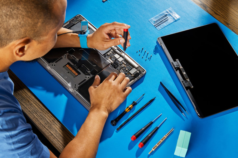 Person repairing a macbook