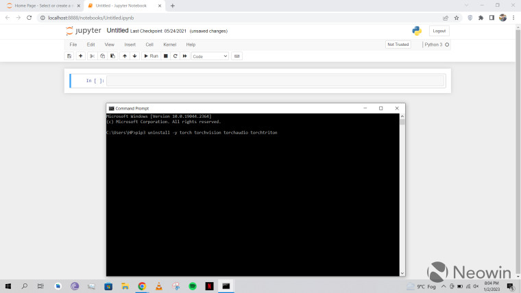 An empty Jupyter notebook and a command prompt open in Windows 10