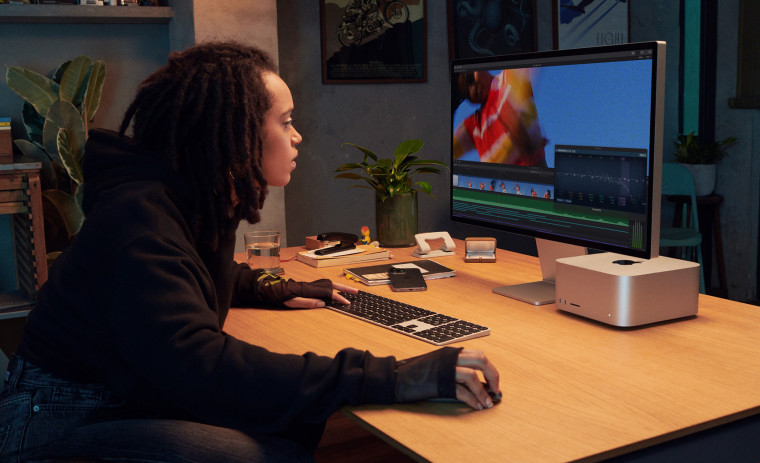 A woman using Apple Mac Studio