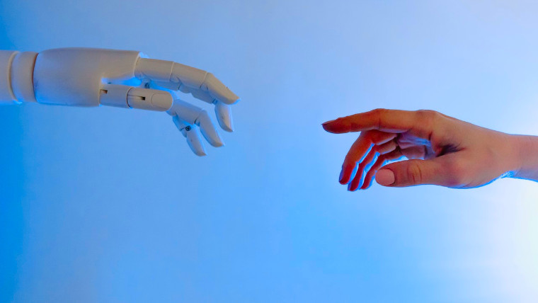 Human and robot hands approaching