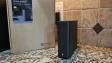 Photo of the front of the Synology BeeStation Plus with the power light on and the box in the backgr