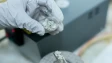 a scientist working with some chemical compound in a lab