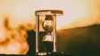 hourglass against a sunset backdrop