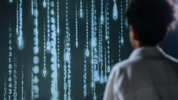 a person staring at a screen displaying random numbers