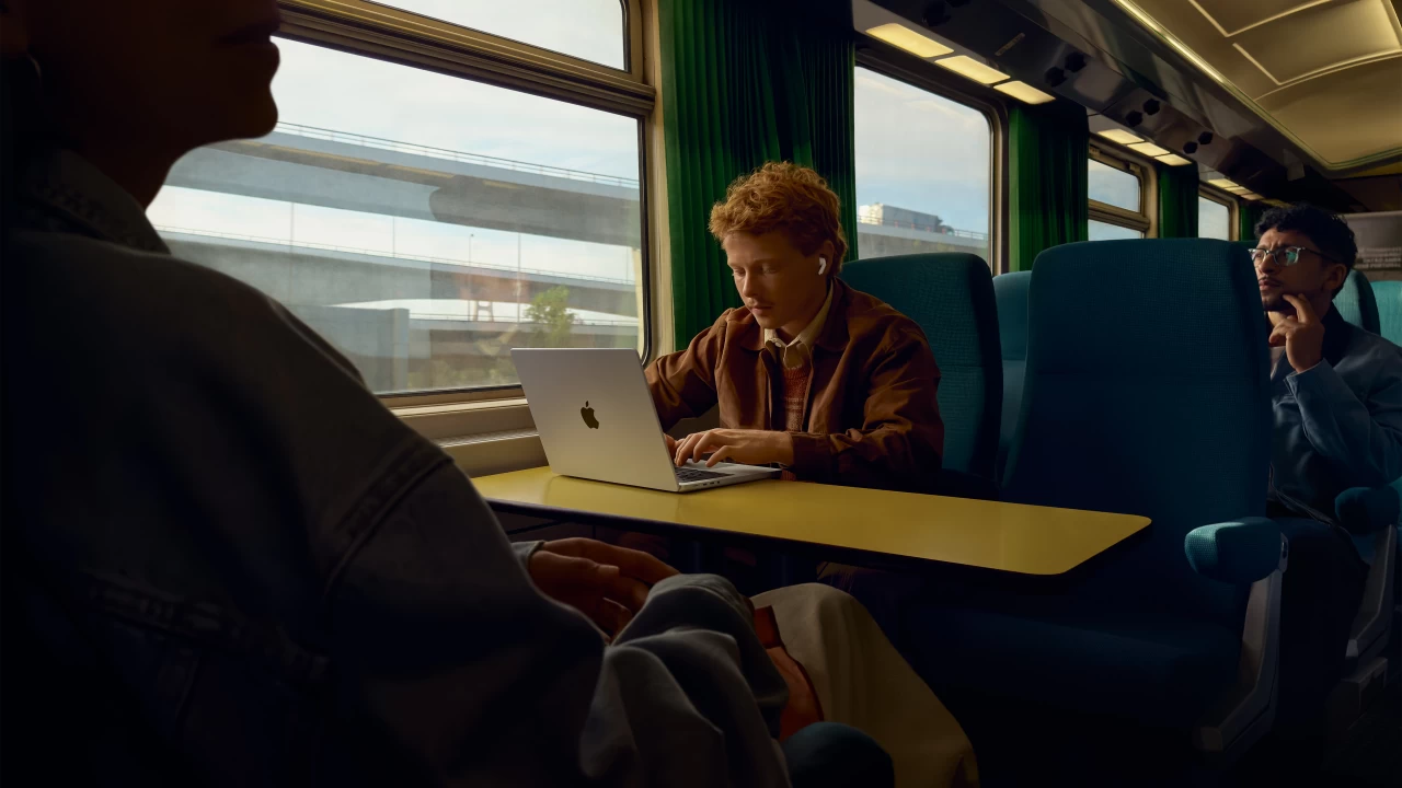 Man wearing Apple AirPods Pro 3 in a train