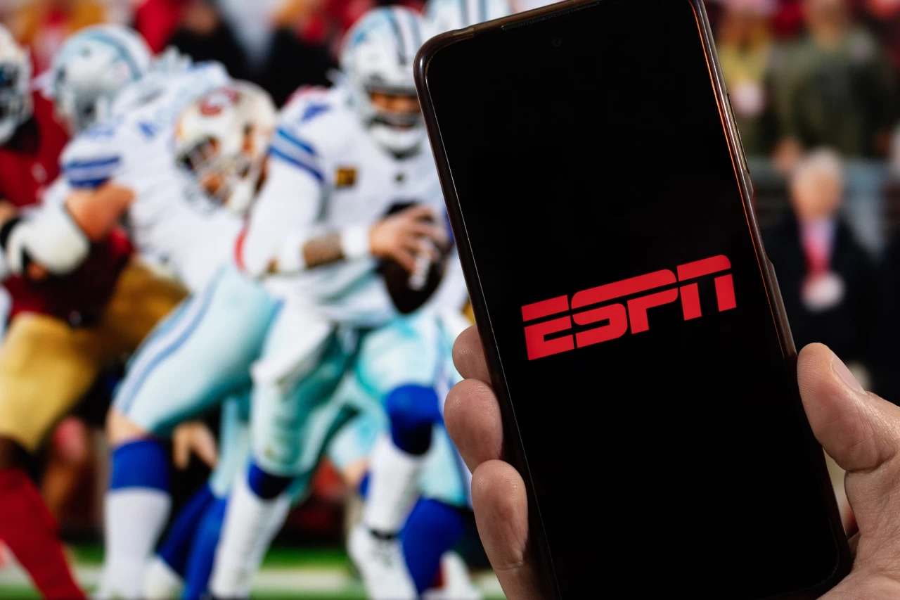 The ESPN logo in front of an American football game