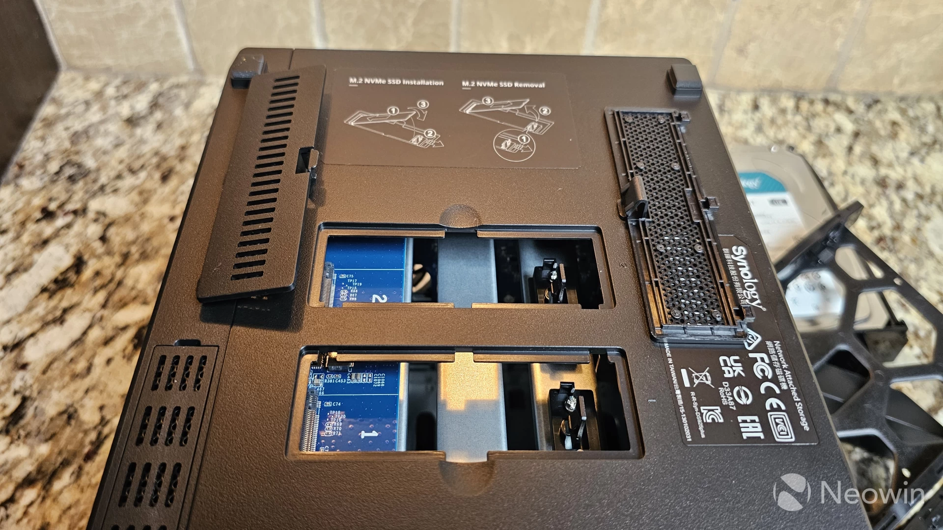 Photo of the bottom of the Synology DS925 showing two exposed NVMe slots