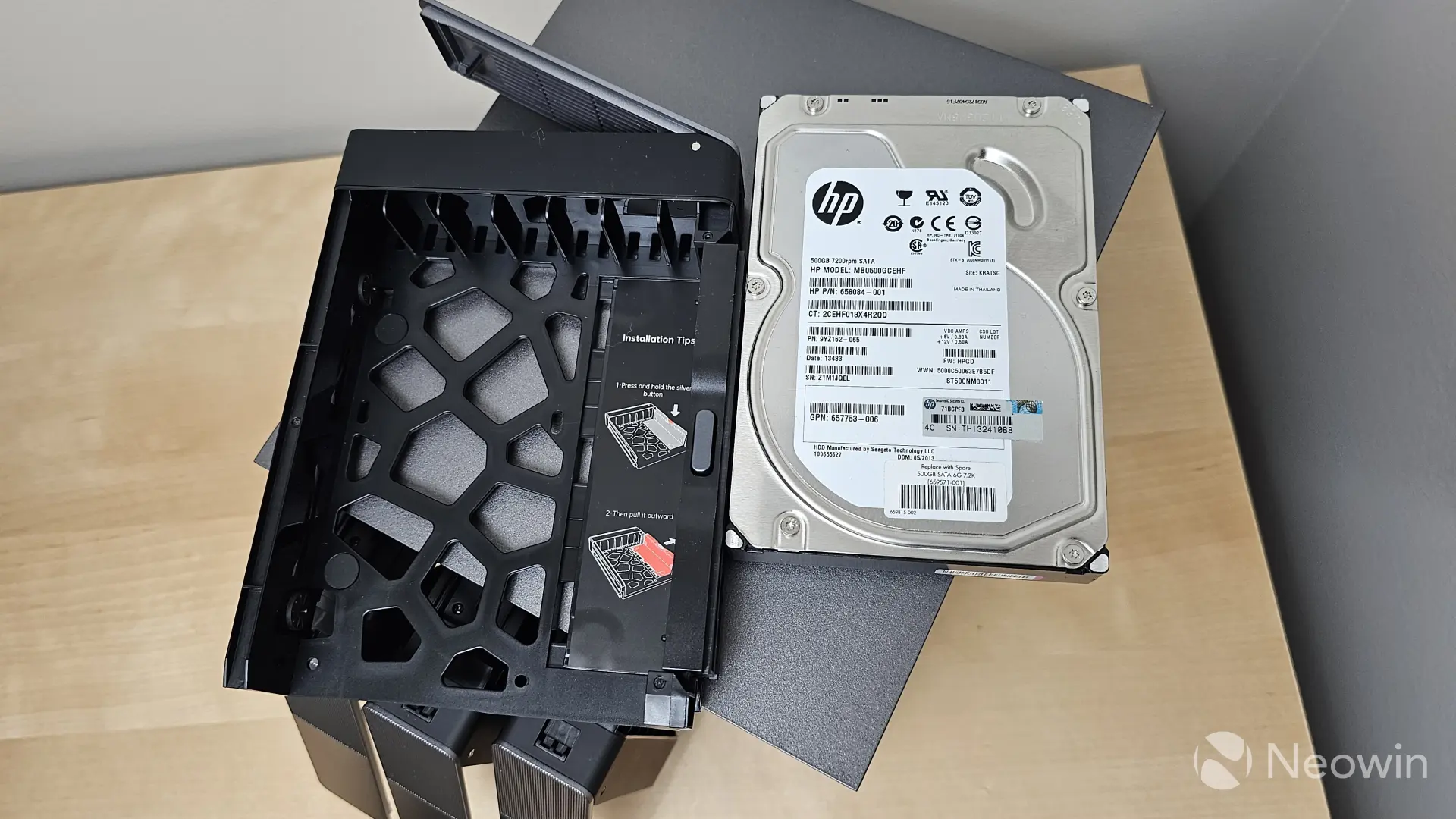 Photograph of a hard drive next to a Zettlab D4 drive sled with instructions on how to install it