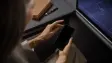 A woman using a phone on a Lufthansa flight