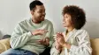 An African American couple communicates through sign language