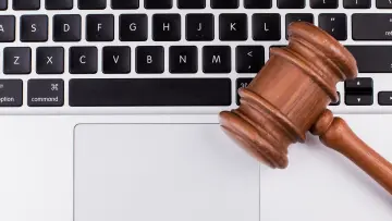 Hammer in front of Apple MacBook