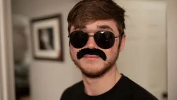 A person wearing a clearly fake moustache