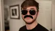 A person wearing a clearly fake moustache