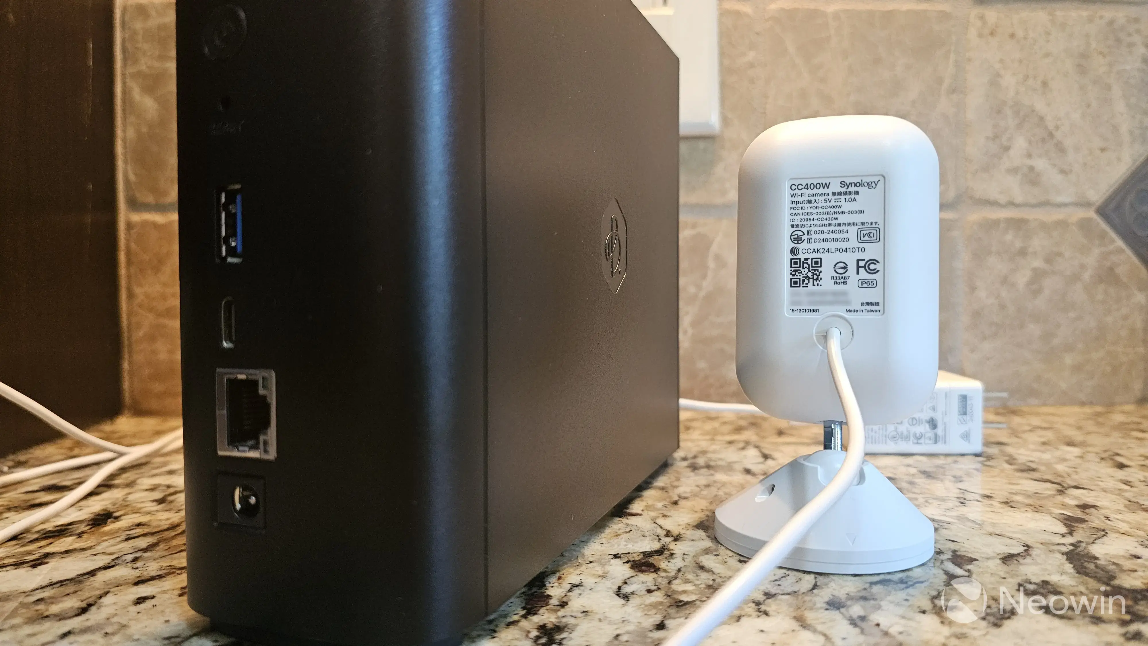 Photo of the back of the Synology CC400W next to the Synology BeeStation