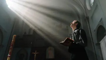god rays falling on a pastor or bishop