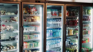 refrigerators stocked with water and different beverages and snacks