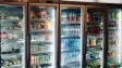 refrigerators stocked with water and different beverages and snacks