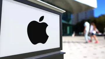 Street signage board with Apple Inc logo Blurred office center and walking people background